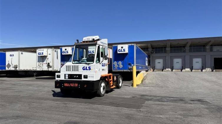 Orange EV Shunt Truck in front of a GLS terminal