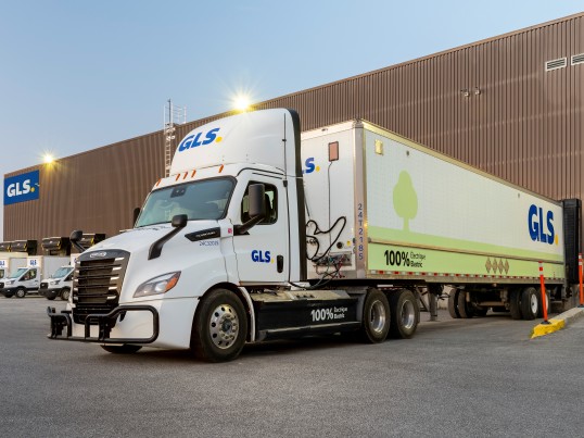 GLS eCascadia truck backed at a terminal.